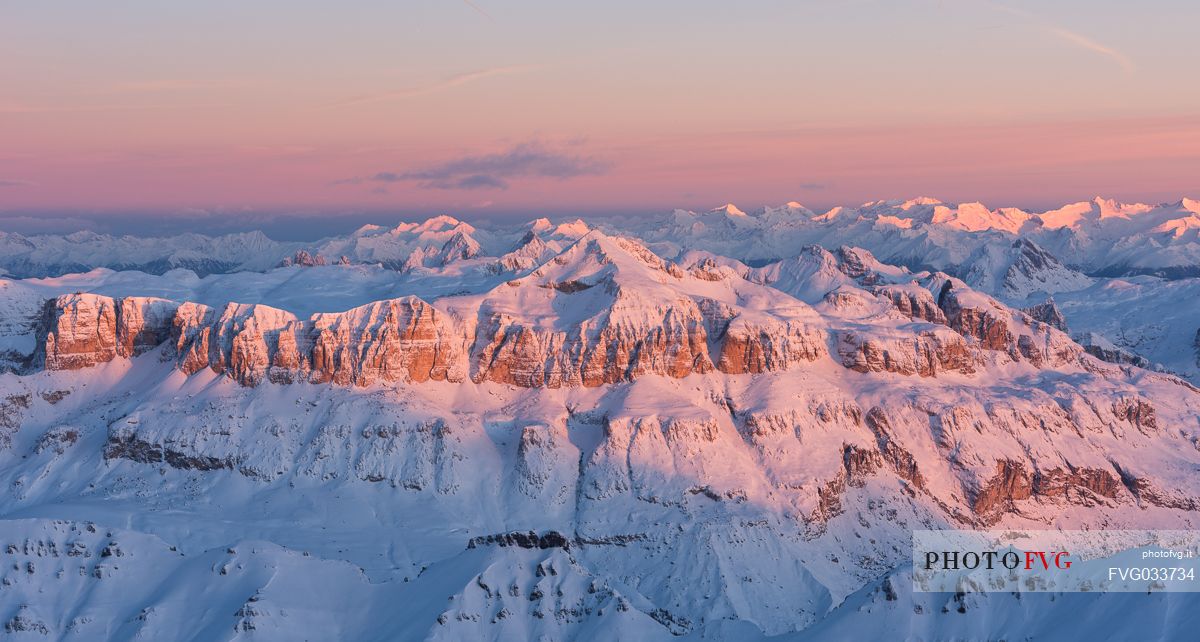 Wonderful sunrise from Marmolada mountain group, the highest peak of Dolomites, toward the Sella peak lighting, dolomites, Italy