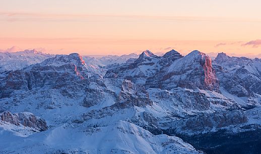 Sunrise from Marmolada mountain group, the highest peak of Dolomites, toward the Tofana di Rozes illuminated, dolomites, Italy