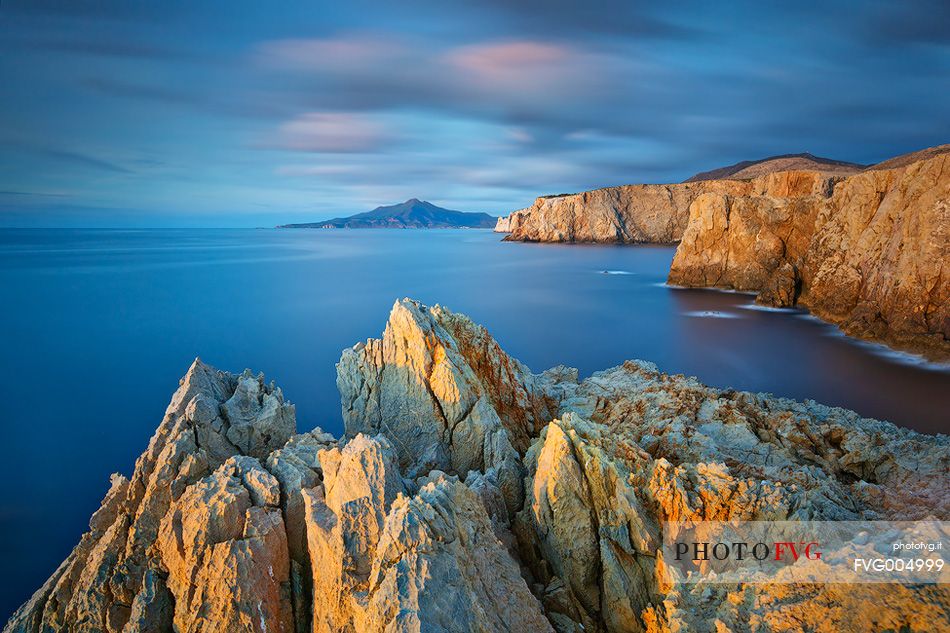 The famous cliffs of the west coast of Sardinia embellished by the light of the sunset in Cala Domestica