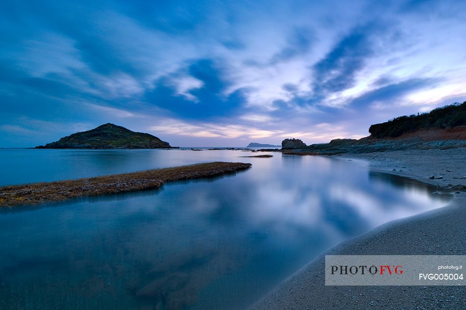 The small island of Campionna located in front of the homonymous beach taken at sunset. This coast is still little known and offers panoramic wild views,Teulada, Sulcis-Iglesiente, Sardinia, Italy