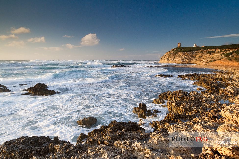 The Lighthouse of Capo Mannu and the typical rocks of the locality well known to surfers to the best waves of the Mediterranean