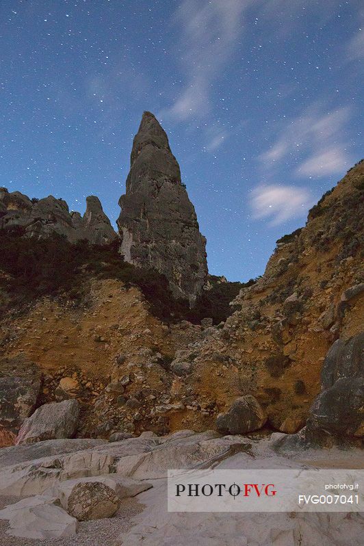 Cala Goloritz photographed during a full moon night. The stars frame the note pinnacle (143 mt)