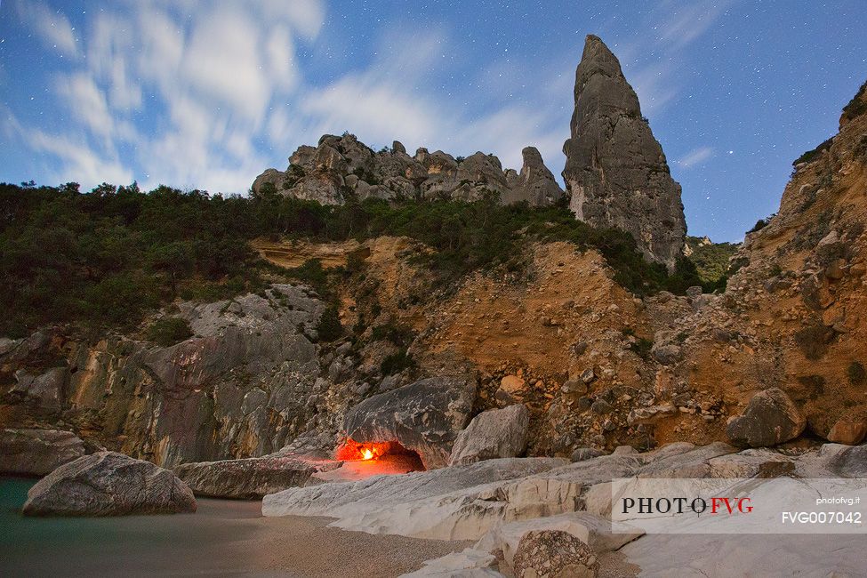 Cala Goloritz photographed during a full moon night. The stars frame the note pinnacle (143 mt)