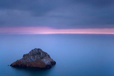 The Scoglo of the Dead is a cliff that rises from the sea just off the south west coast of Sardinia. Here it is taken at sunset, Nebida, Sulcis-Iglesiente, Sardinia, Italy The Scoglo of the Dead is a cliff that rises from the sea just off the south west coast of Sardinia. Here it is taken at sunset, Nebida, Sulcis-Iglesiente, Sardinia, Italy