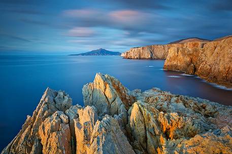 The famous cliffs of the west coast of Sardinia embellished by the light of the sunset in Cala Domestica The famous cliffs of the west coast of Sardinia embellished by the light of the sunset in Cala Domestica