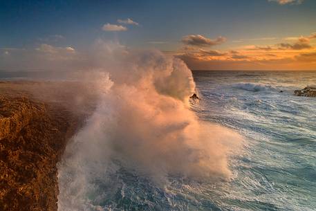 A wave fringes on the rocks of Capo Mannu with all its power. The high cliff about seven meters, it is submerged in water and leave in the eyes of the curious, wonder and awe, fear and fascination.