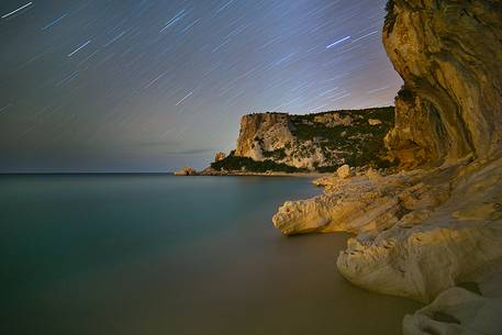 Cala Luna. One of the most famous bays of Sardinia photographed at night with the typical rocks eroded by the sea. The sea over the centuries has created fascinating caves on the sea