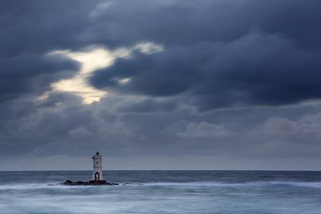 The famous small lighthouse of Mangiabarche (Calasetta) during a little winter storm 