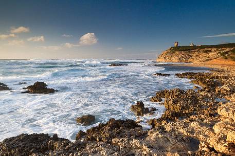 The Lighthouse of Capo Mannu and the typical rocks of the locality well known to surfers to the best waves of the Mediterranean