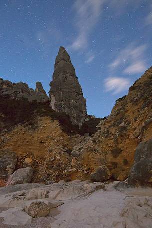 Cala Goloritz photographed during a full moon night. The stars frame the note pinnacle (143 mt)