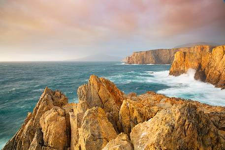 Cala Domestica, a famous fjord for its pure white sand, the presence of dunes with vegetation and an impressive cliff overlooking the sea Cala Domestica, a famous fjord for its pure white sand, the presence of dunes with vegetation and an impressive cliff overlooking the sea