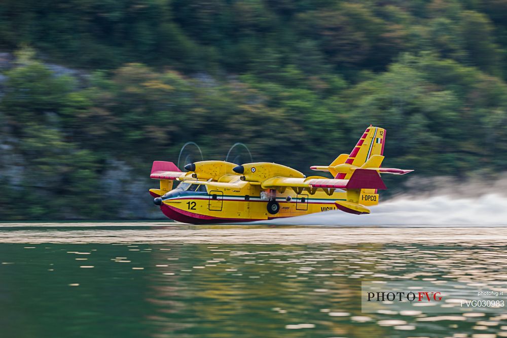 Firefighting airplane, Bombardier 415 - Canadair CL-415, taking water from the Lake, Somplago, Cavazzo Carnico, Udine, Italy. 