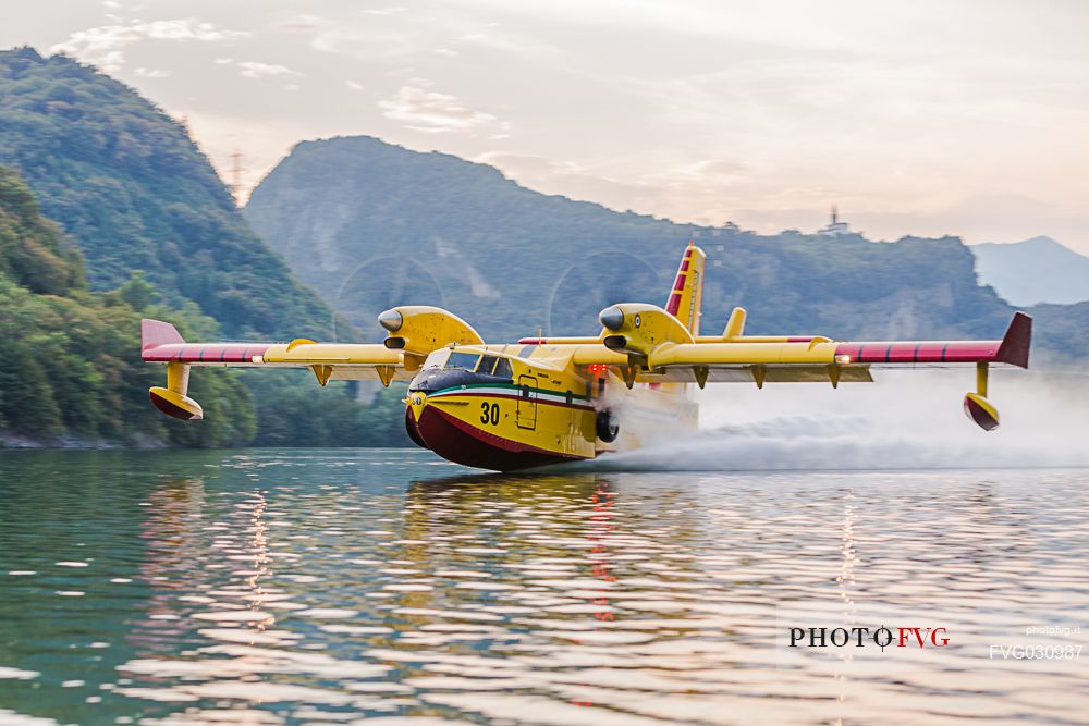 Firefighting airplane, Bombardier 415 - Canadair CL-415, taking water from the Lake, Somplago, Cavazzo Carnico, Udine, Italy. 
