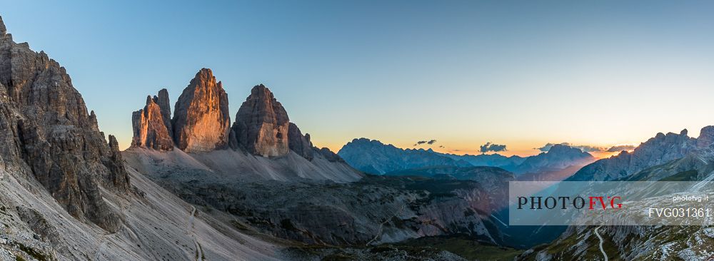 The north faces of the Tre Cime di Lavaredo, three peaks of Lavaredo, at sunset, Sexten Dolomites, Italy.