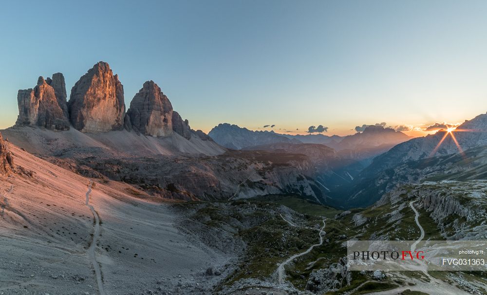 The north faces of the Tre Cime di Lavaredo, three peaks of Lavaredo, at sunset, Sexten Dolomites, Italy.