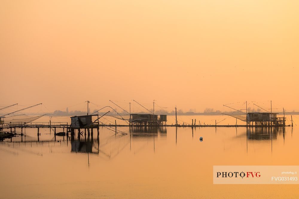 Typical fishing house called Padellone or Bilancione in Comacchio lagoon at sunset, Ferrara, Emilia Romagna, Italy