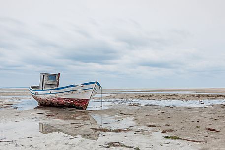 Boat wreck in Grado beach, Friuli Venezia Giulia, Italy Boat wreck in Grado beach, Friuli Venezia Giulia, Italy