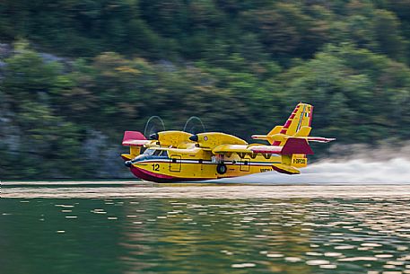 Firefighting airplane, Bombardier 415 - Canadair CL-415, taking water from the Lake, Somplago, Cavazzo Carnico, Udine, Italy. 