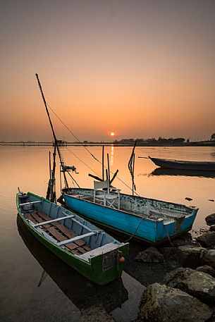 Typical fishing boats in Comacchio lagoon at sunset, Ferrara, Emilia Romagna, Italy