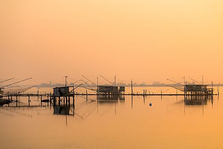 Typical fishing house called Padellone or Bilancione in Comacchio lagoon at sunset, Ferrara, Emilia Romagna, Italy