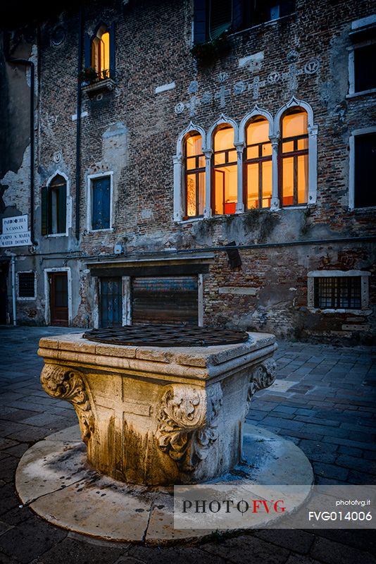 Typical well in a small square at twilight in Venice, Veneto, Italy, Europe