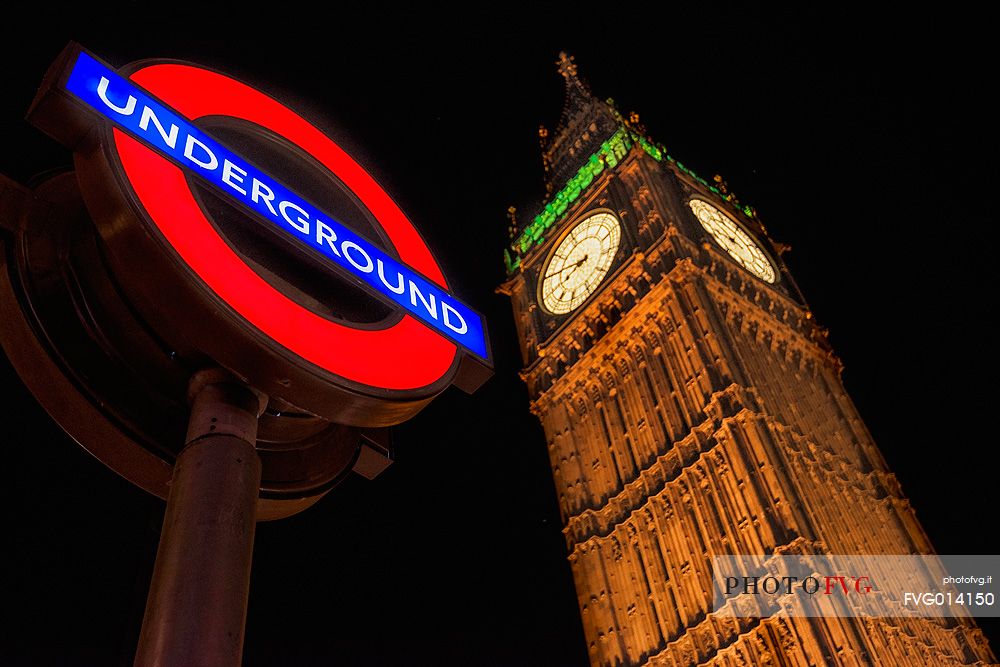 Night view of The Big Ben Tower and underground station sign, London, United Kingdom