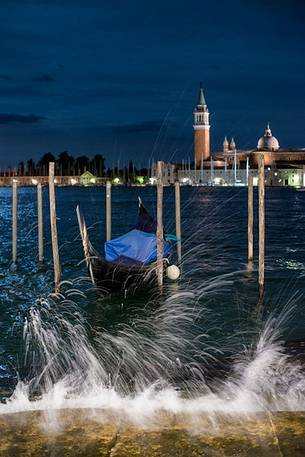 Gondola moored near San Marco's square by night, in the background the San Giorgio Maggiore Basilica, Venice, Veneto, Italy, Europe