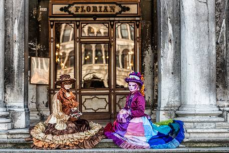 Carnival masks sitting outside the historical bar Florian in Piazza San Marco square, Venice, Italy, Europe