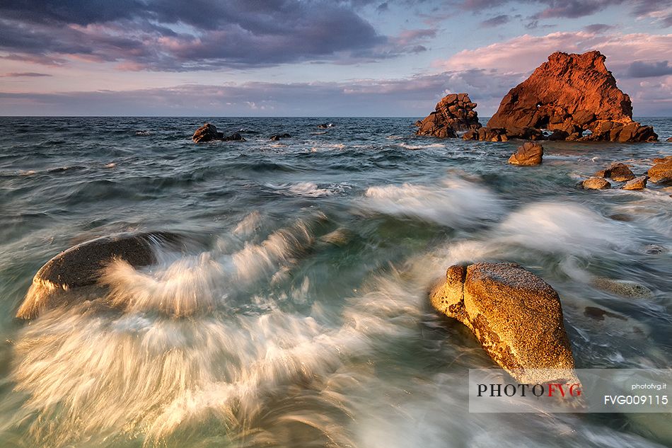 The roar of the sea, with all its force, and the last warm light of day cleave the reef of Briatico Marina