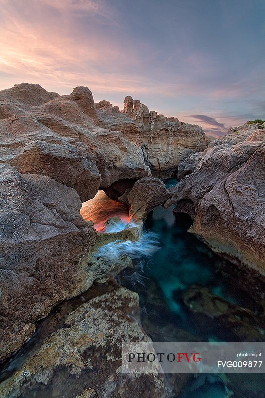 The light makes its way through the cracks of the Rock in the Bay Statues, within walking distance of Tropea.