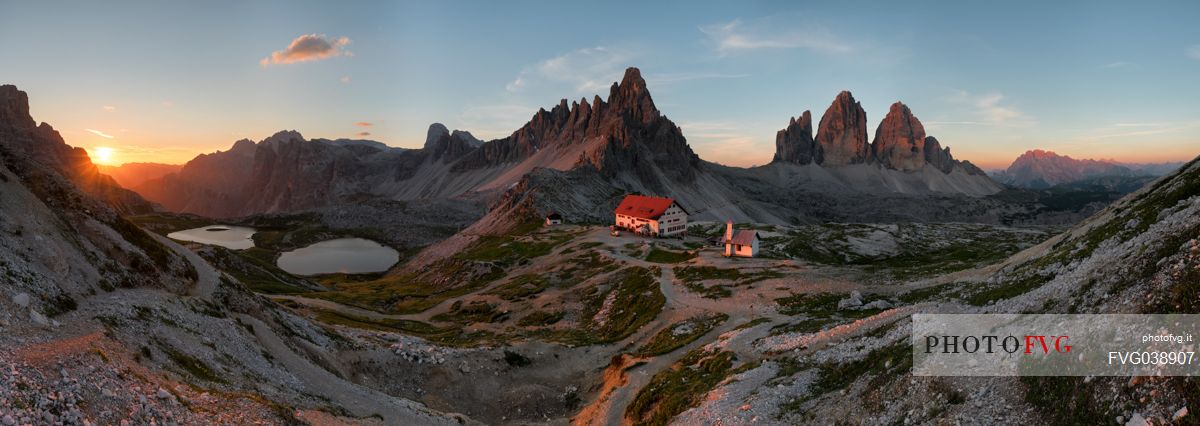 Panoramic view of the Tre Cime di Lavaredo, the Piani lake and the Locatelli refuge at dawn, Sexten dolomites, South Tyrol, Italy, Europe
