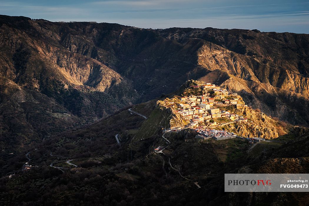 Roccaforte Del Greco illuminated by the light of a winter sunset