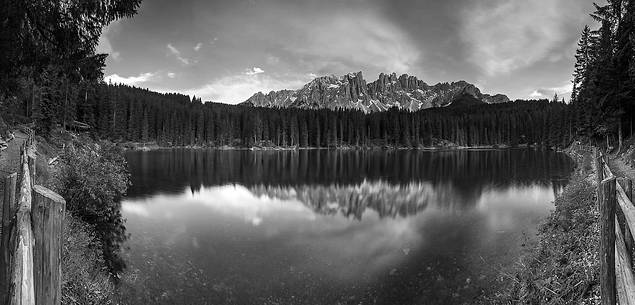 The Latemar is reflected in the Carezza Lake at sunset