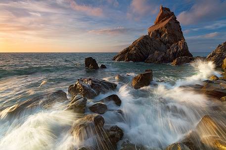 The Pizzuta Rock in Parghelia, illuminated by the golden light of sunset The Pizzuta Rock in Parghelia, illuminated by the golden light of sunset