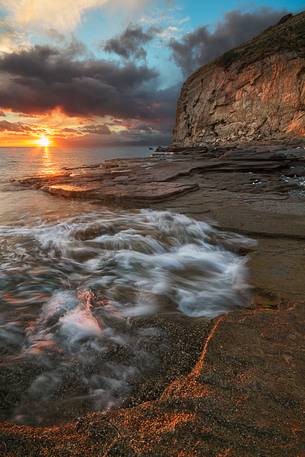 The cliff Leucopetra photographed at sunset from Cape Riaci