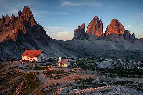 The Tre Cime of Lavaredo and the Locatelli refuge at the first light of dawn, Sexten dolomites, South Tyrol, Italy, Europe
