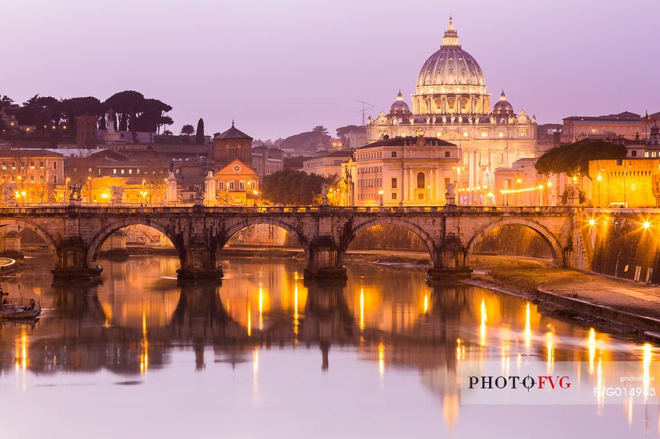 Rome at sunset, Ponte Sant'Angelo on the Tiber and in the background the St. Peter's Basilica