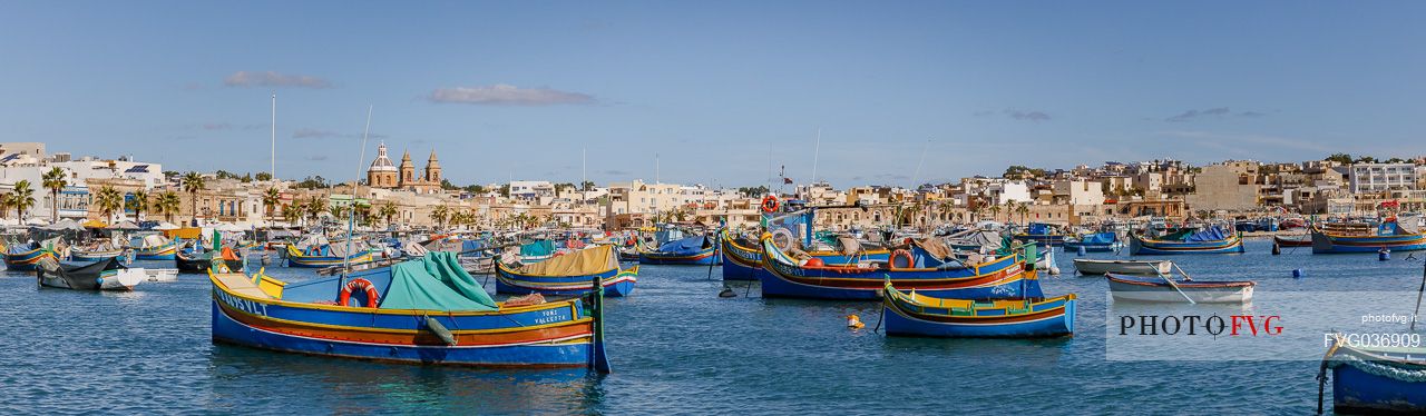 The historic city of Marsaxlokk on the island of Malta, famous for its colorful fishing boats called Iuzzu