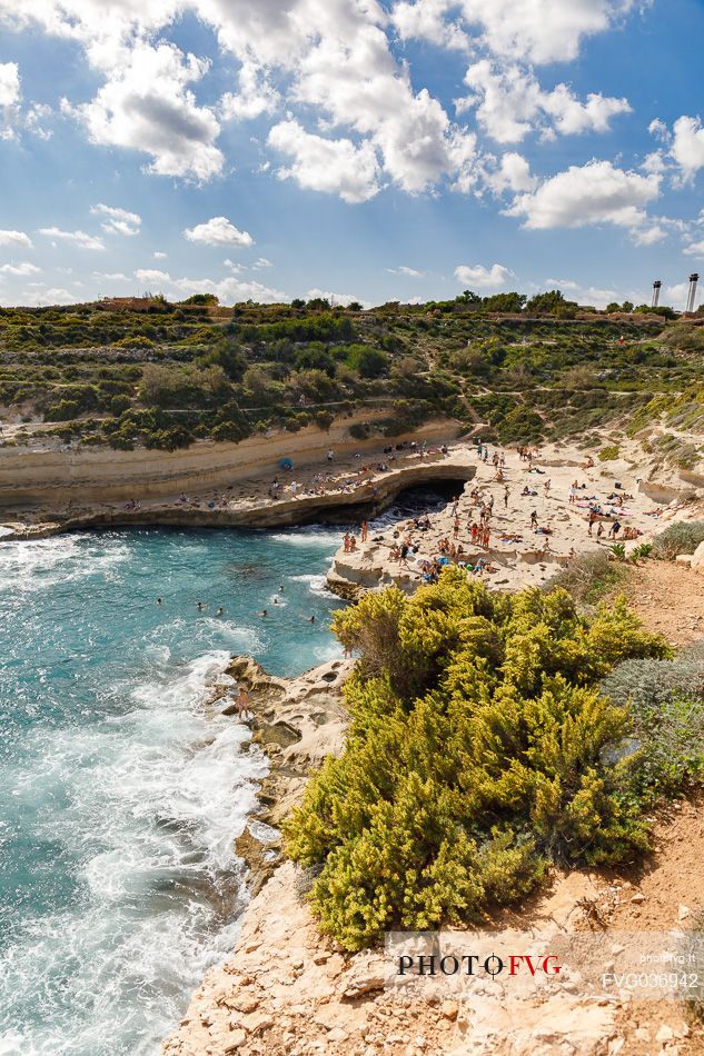 Summer holiday in St. Peter's Pool, one of the most beautiful natural pools on the island of Malta, Europe