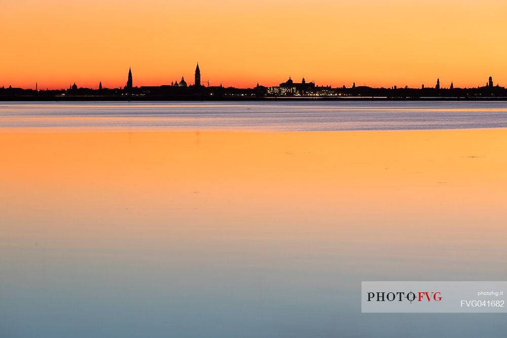 Sunset towards the island of Venice from the colorful island of Burano, Veneto, Italy, Europe