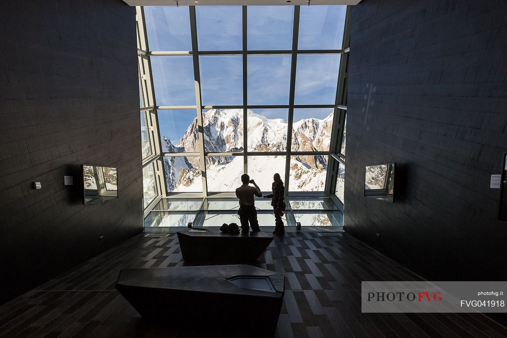 Tourists inside the cableway station of Punta Helbronner taking a picture of Monte Bianco peak, Skyway Mont Blanc, Courmayeur, Aosta Valley, Italy, Europe