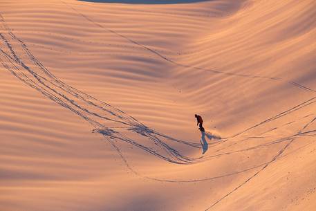 Snowboarding on Mount Grappa at sunset