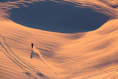 Snowboarding on Mount Grappa at sunset