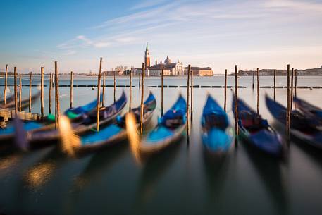 Gondolas at sunset, in the background the Church of San Giorgio Maggiore Gondolas at sunset, in the background the Church of San Giorgio Maggiore