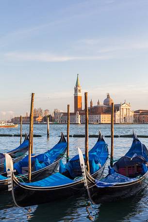 Gondolas at sunset, in the background the Church of San Giorgio Maggiore Gondolas at sunset, in the background the Church of San Giorgio Maggiore
