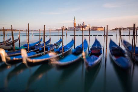 Gondolas at sunset, in the background the Church of San Giorgio Maggiore Gondolas at sunset, in the background the Church of San Giorgio Maggiore