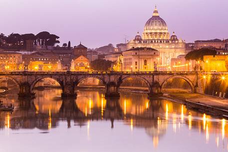 Rome at sunset, Ponte Sant'Angelo on the Tiber and in the background the St. Peter's Basilica
