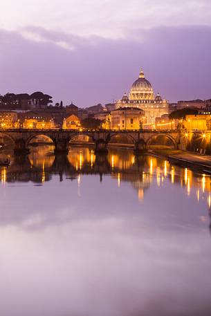 Rome at sunset, Ponte Sant'Angelo on the Tiber and in the background the St. Peter's Basilica