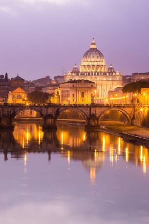 Rome at sunset, Ponte Sant'Angelo on the Tiber and in the background the St. Peter's Basilica