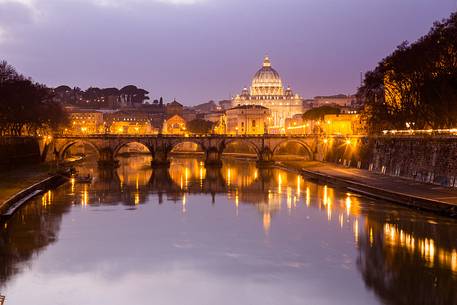 Rome at sunset, Ponte Sant'Angelo on the Tiber and in the background the St. Peter's Basilica